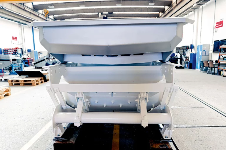 Rear view of a JOEST conveying trough with vibratory drive for industrial bulk material handling