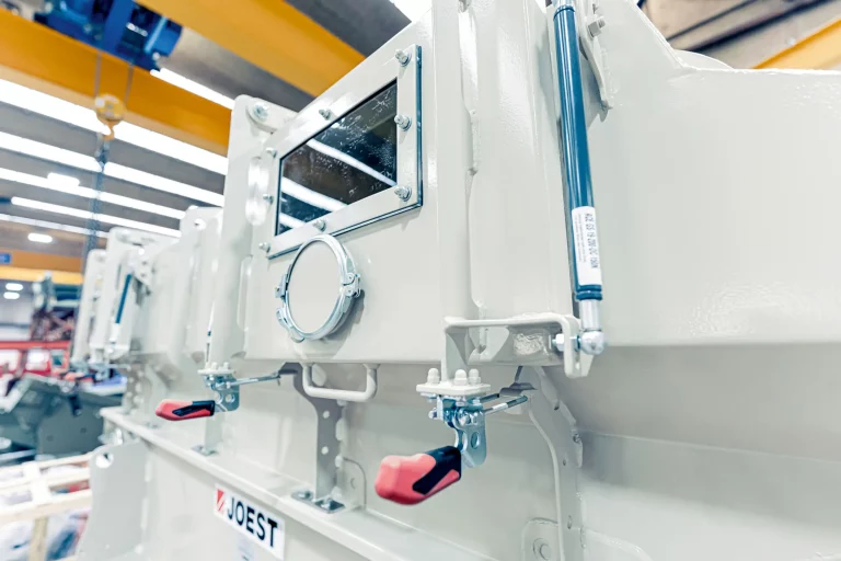 Close-up of a JOEST DWFK cooler featuring inspection window and toggle latches for industrial bulk material cooling.
