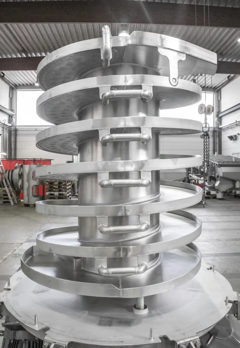 JOEST spiral elevator with open spiral design and integrated water cooling system.