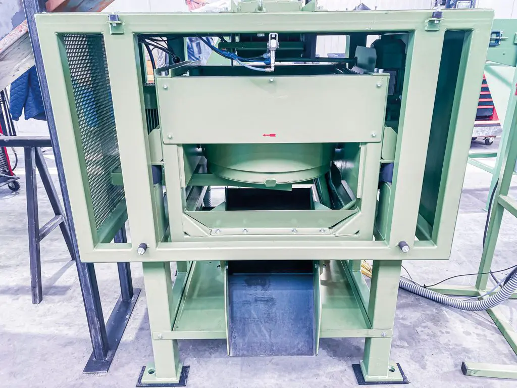 Industrial de-oiling centrifuge for efficient removal of lubricants and oil from metal parts.